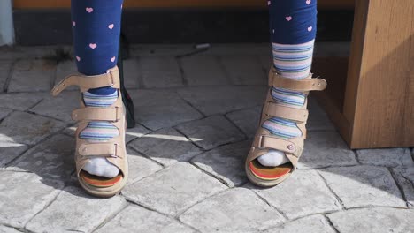 child with orthopedic shoes and socks