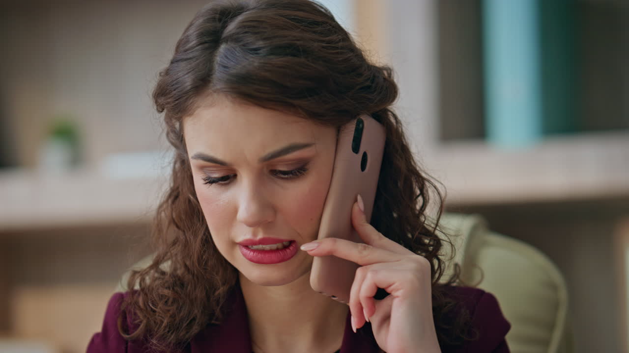 Concerned businesswoman talking cellphone in agency office closeup. Serious lady