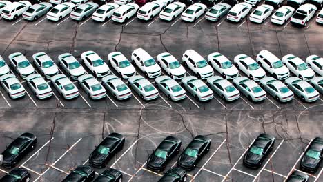 Parking-lot-full-of-Unmarked-Police-cars-aerial-shot-flying-over-in-4k