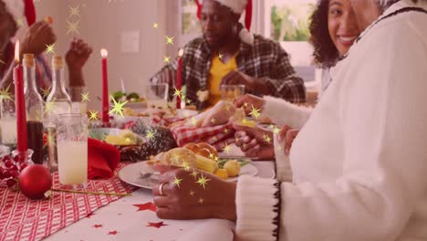 animation of hohoho text over african american family having dinner