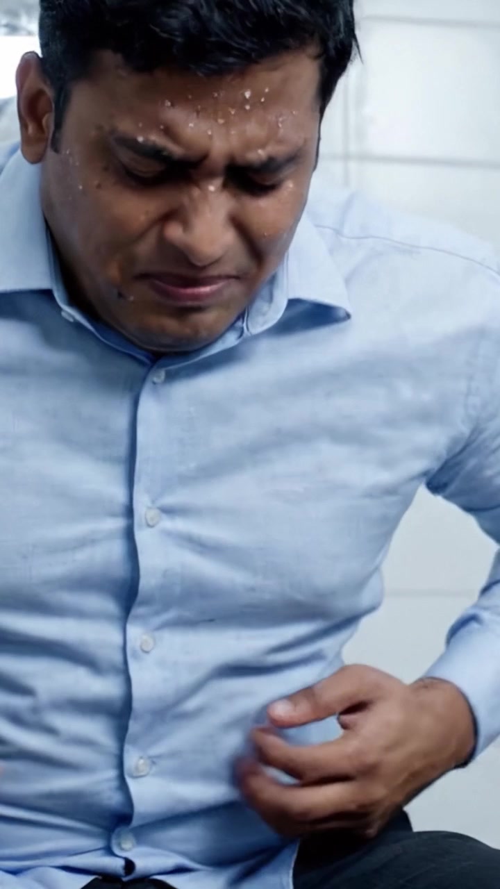Struggling with Severe Abdominal Pain: A Depiction of Distress and Discomfort Experienced During a Sudden Gastrointestinal Crisis.