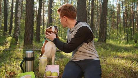 teenager with beagle dog on a forest picnic