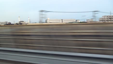 the view of tokyo passing from inside of the shinkansen bullet train