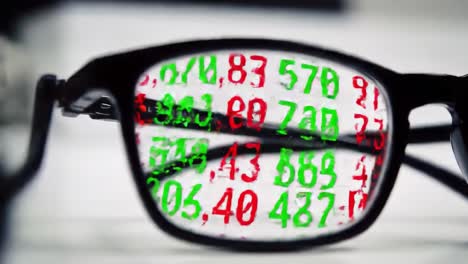 analyzing stock market data through spectacles: a close-up view of financial figures reflected in glasses, highlighting market trends and numbers