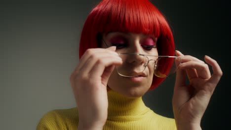 woman in red wig and yellow sweater