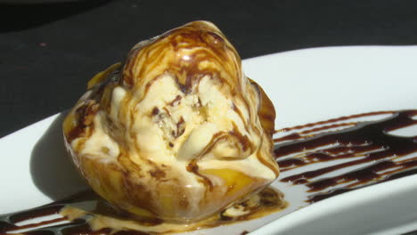 peach with vanilla ice cream and chocolate sauce