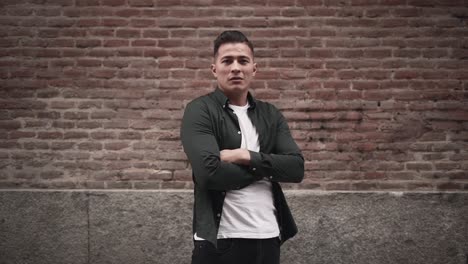 stylish man in front of brick wall