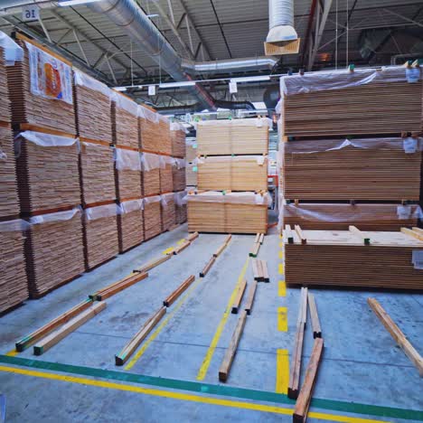 stacks of lumber and wood planks in a warehouse