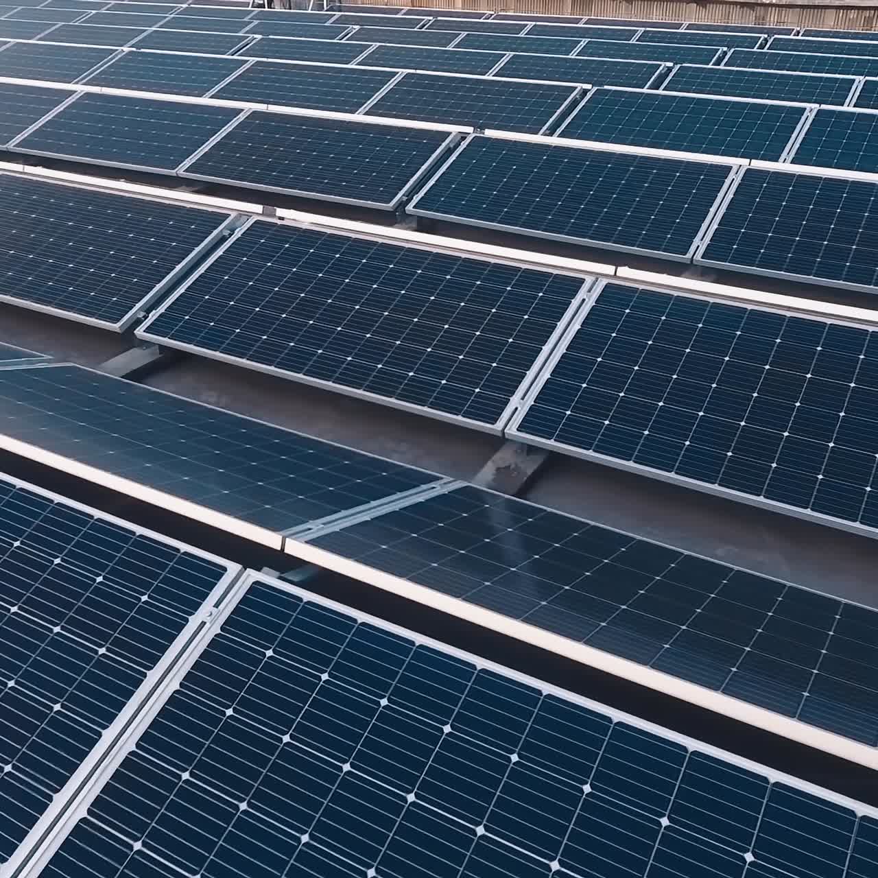 Many modern photovoltaic panels on the solar farm.New solar panels receiving clean energy from the sun. Motion camera back.