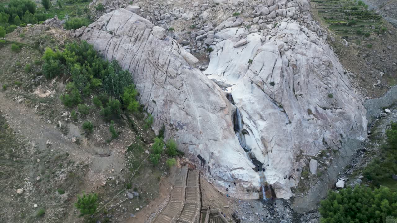 Aerial drone view of a beautiful rock formation, badlands in a lush, rugged mountain valley in Kabul, Afghanistan