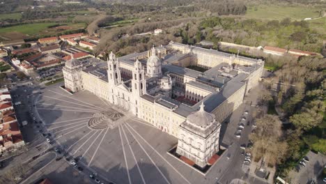 mafra monastery in sunset, aerial orbit descending, establish religious building