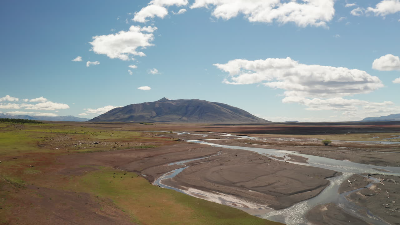 Flying Low Altitude over the Patagonian Steppe near Santa Cruz, Argentina.Panoramic View of the Deserted Landscape with Beautiful Sunny Day, Blue Sky and Fluffy Clouds