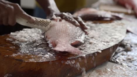 mahe seychelles man scaling fishing in the town market of victoria