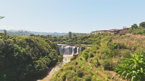 Rice-terrace-fields-revealing-to-huge-waterfall-in-Madagascar-countryside