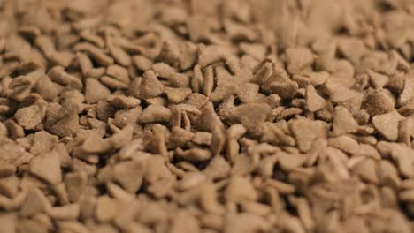 Slow-motion-shot-Petfood-Triangle-Shape-grains-slowly-falling-on-Pile---static