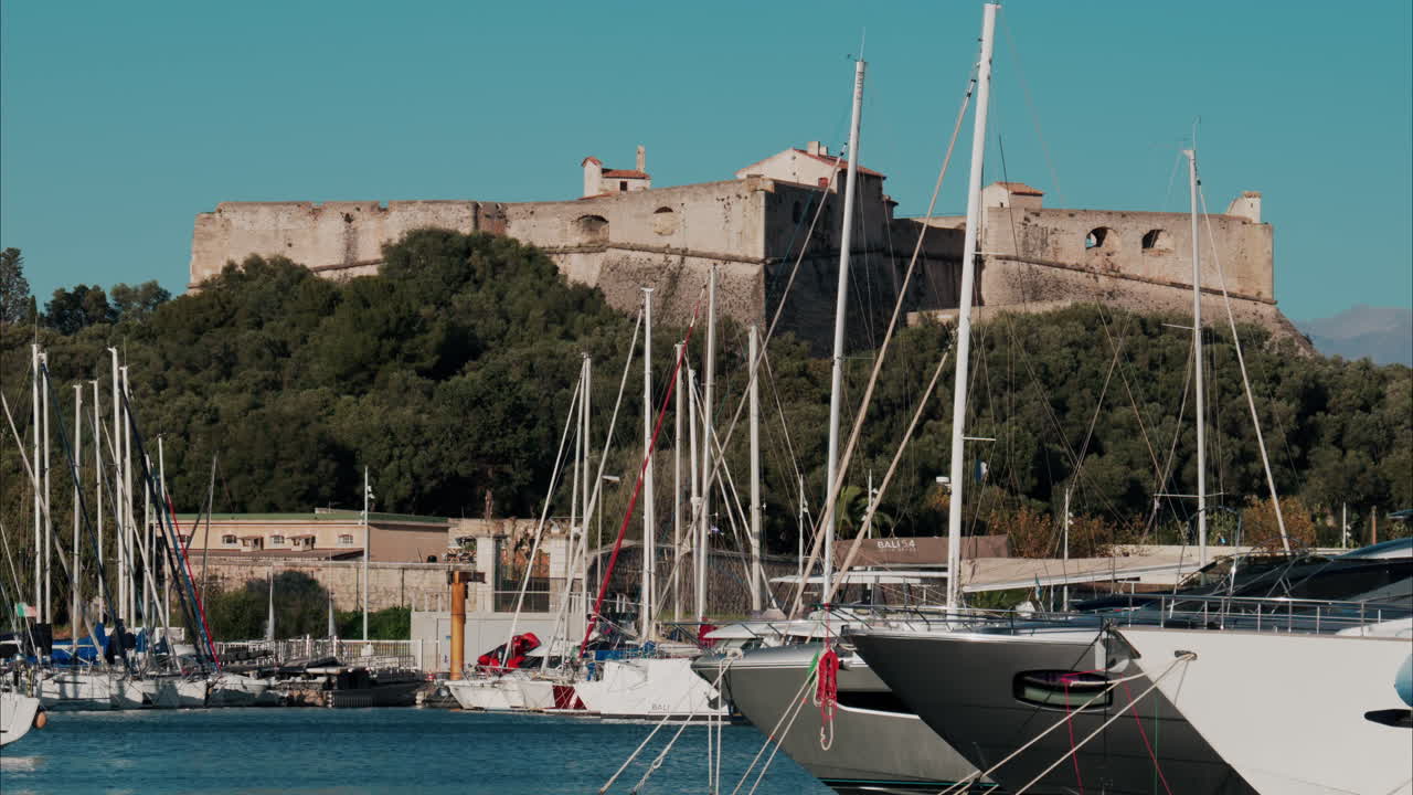 Boats docked in the Port Vauban with he Fort Carre on the background in Antibes, France