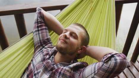 caucasian man spending time at home, looking away and smiling