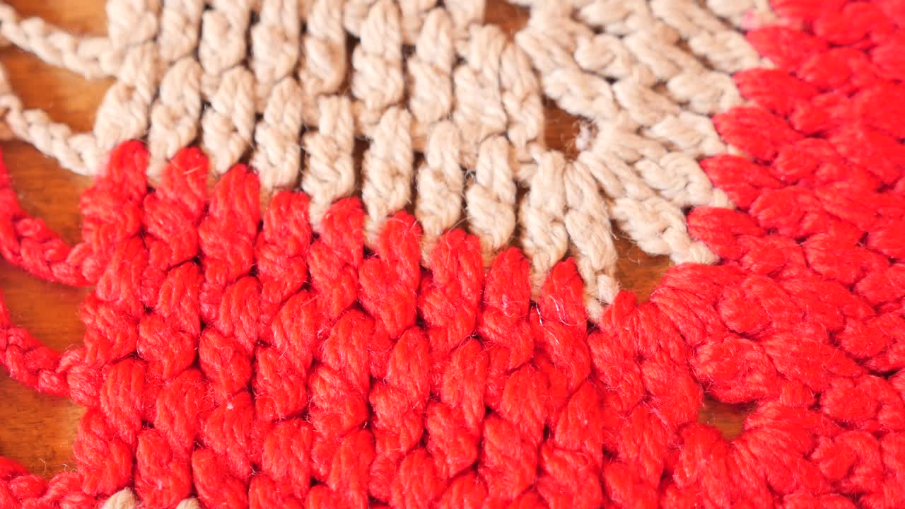 Close-up of a Knitted Table Mat with Red and Beige Colors