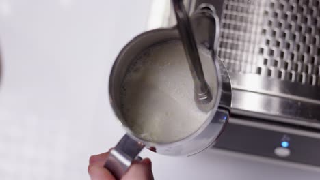 Barista-making-milk-foam-froth-for-latte-art,-cappuccino