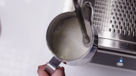 barista making milk foam froth for latte art, cappuccino