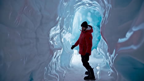 man exploring a stunning blue ice cave