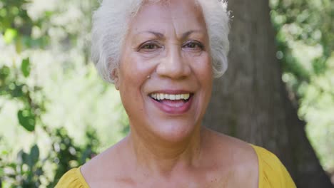 senior mixed race woman smiling and looking at the camera