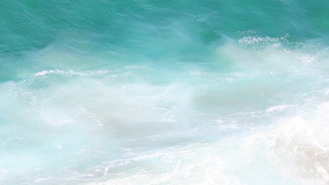 dynamic ocean waves hitting a sandy beach