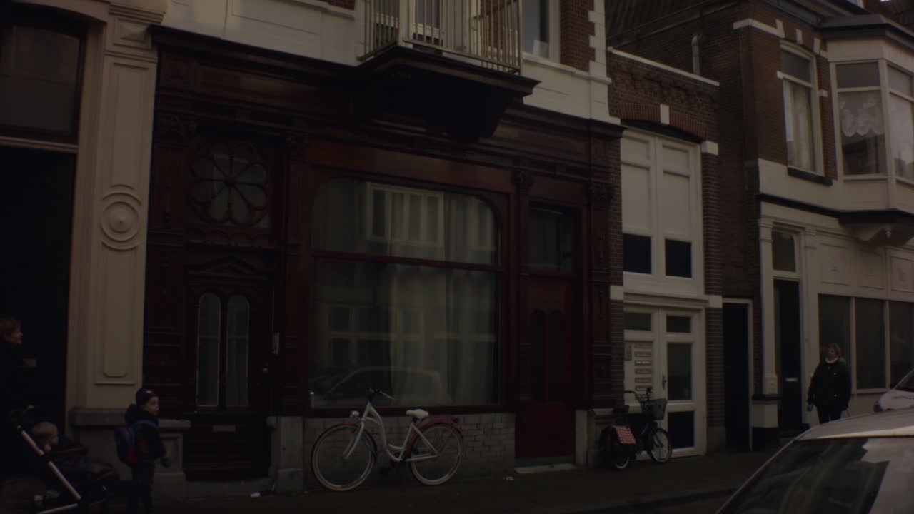 Old Ijmuiden - Netherland - January 21st 2019 : straight down motion view of a classical vintage building on street in dutch neighborhood close to harbor during winter