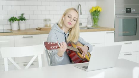 Female-guitarist-practicing-at-home