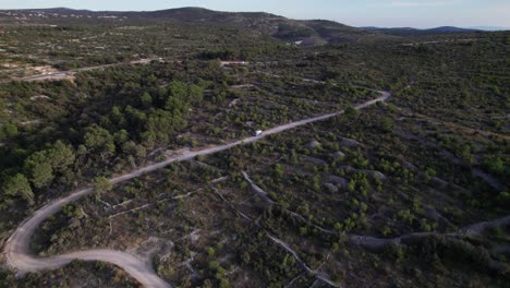 Campervan-parked-on-dirt-road-in-rural-Croatia,-travel-lifestyle,-aerial