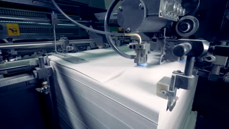 industrial mechanism is moving paper sheets on a high speed.