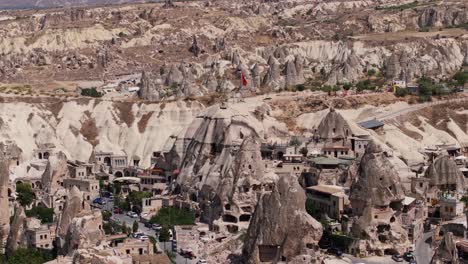 drone captures a stunning aerial view of cappadocia’s rocky terrain and valleys at sunrise, highlighting the region's geological formations