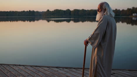 an old man contemplating at sunset