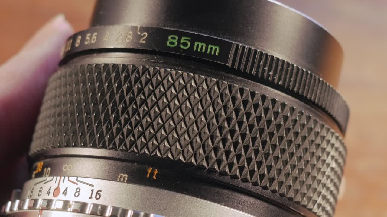 Woman Photographer Cleans a Film Photography Lens