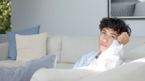 relaxing on couch, teenage boy with curly hair enjoying peaceful moment