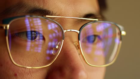 Close-Up of a Young Adult's Face Through Reflective Glasses, Capturing Data Patterns and Light Effects in a Thoughtful Moment of Analysis