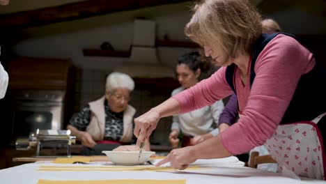 Aged-women-cooking-tortellini-together-in-kitchen