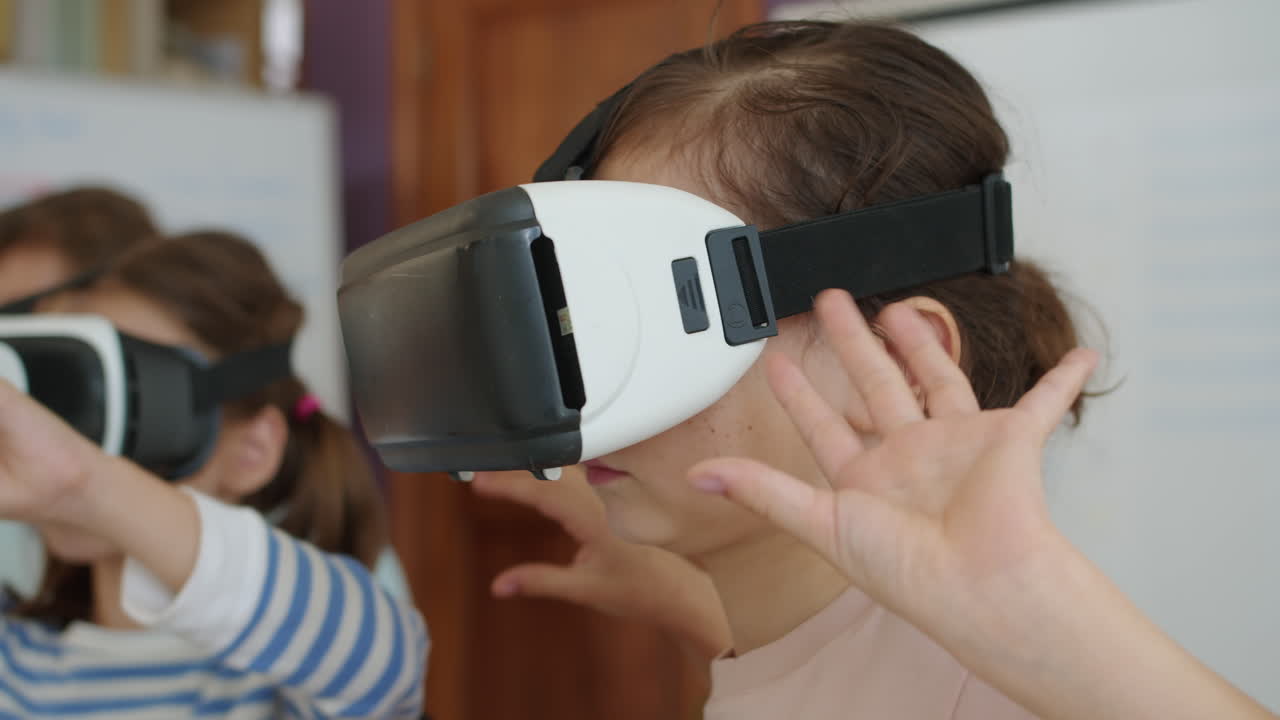 Little Girls in VR Glasses Studying at Group Class at School