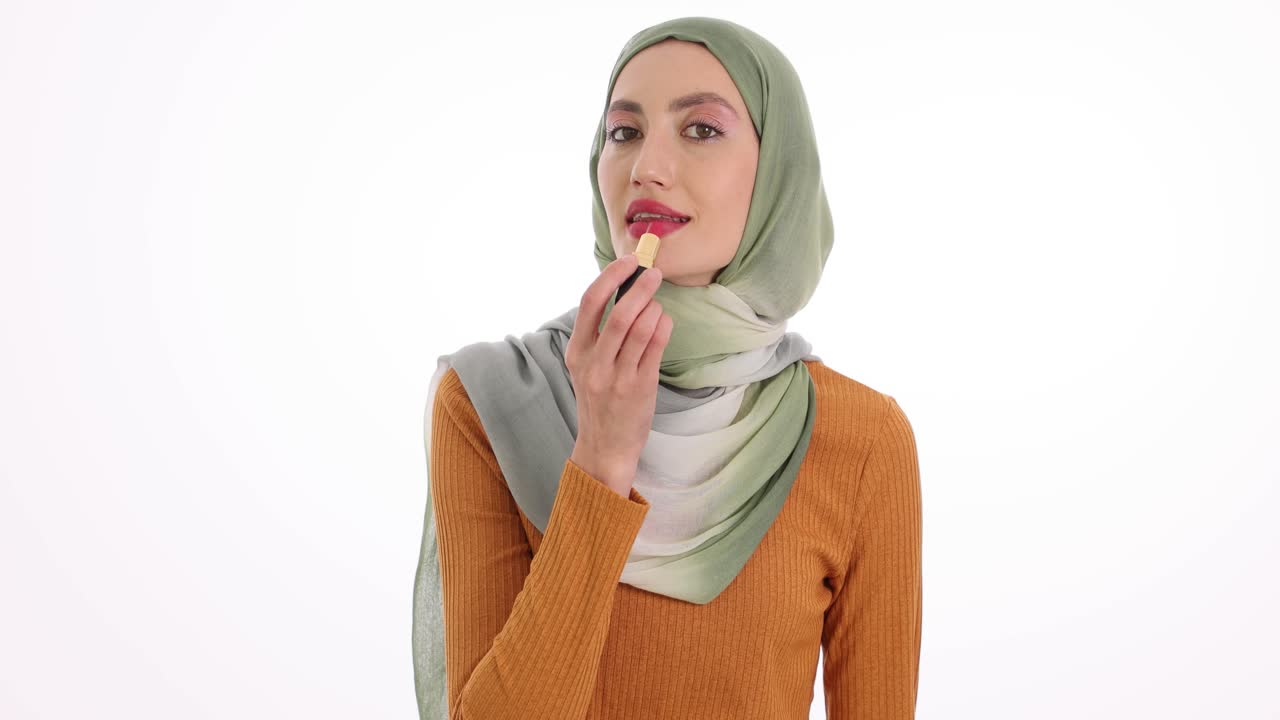 Young Muslim Woman Applying Lipstick