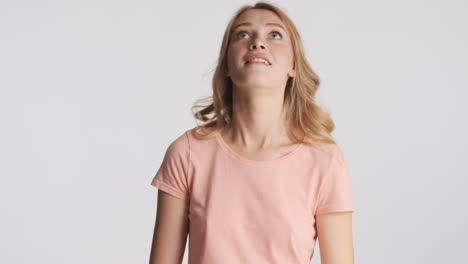 caucasian woman showing wait gesture and thinking on camera.