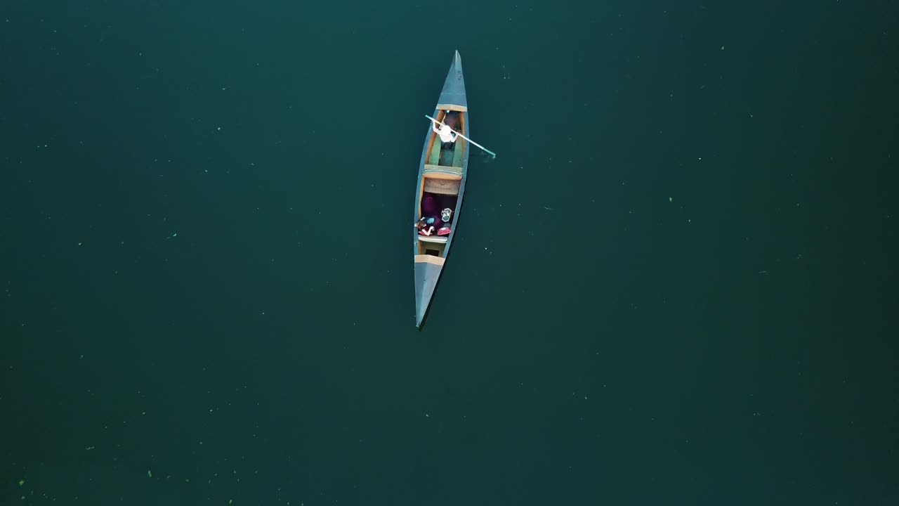 gondolier is floating on the Grand Canal in Venice with a tourist. Aerial view