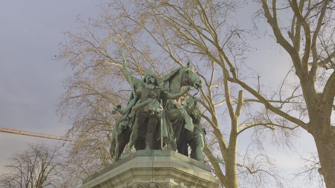 Charlemagne et ses Leudes or Charlemagne and His Paladins, monumental bronze statue in Paris, bare branches in background, France. Low angle pov