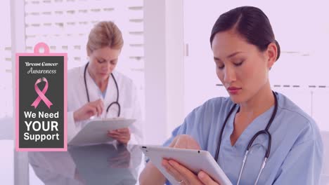 animation of breast cancer awareness text over diverse female doctors using tablet