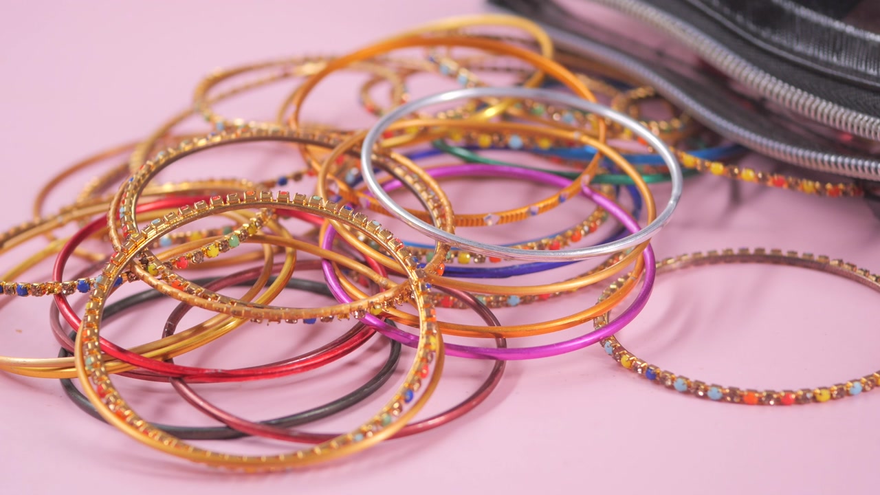 Assorted Colorful Bangles on a Pink Background