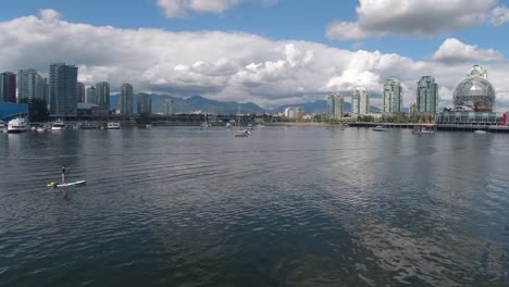 aerial hold over false creek olympic village where paddle board dock at rental dock yachts - dinner cruise boats park by posh residential luxury condominiums close to science world vancouver city01-10