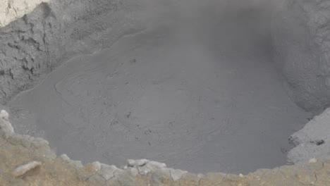 boiling mud pot in iceland's geothermal field. close-up