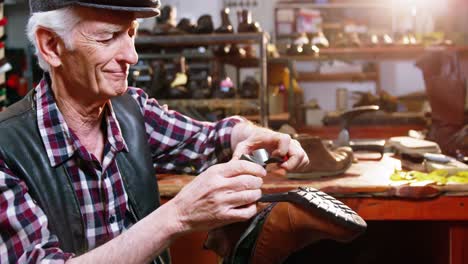 shoemaker repairing a shoe