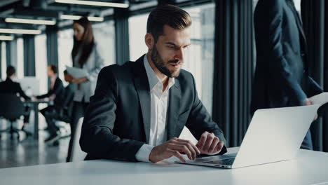 businessman working on laptop in a modern office environment