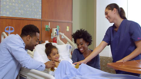 nurse with parents and child in hospital ward shot on r3d
