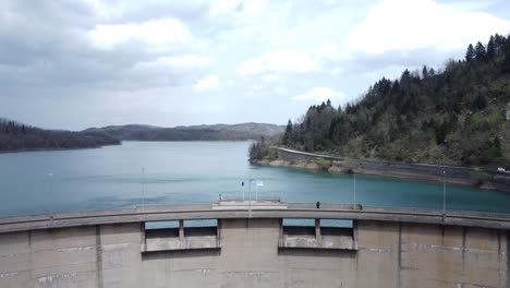 Drone-flight-over-a-hydroelectric-dam-and-a-crystal-lake-|-4K